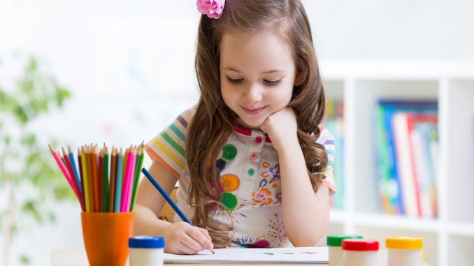 39038051 - cute preschooler child girl drawing pencil at home